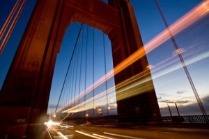 Long exposure of cars passing through one of the towers of the Golden Gate Bridge. Shot in San Francisco.